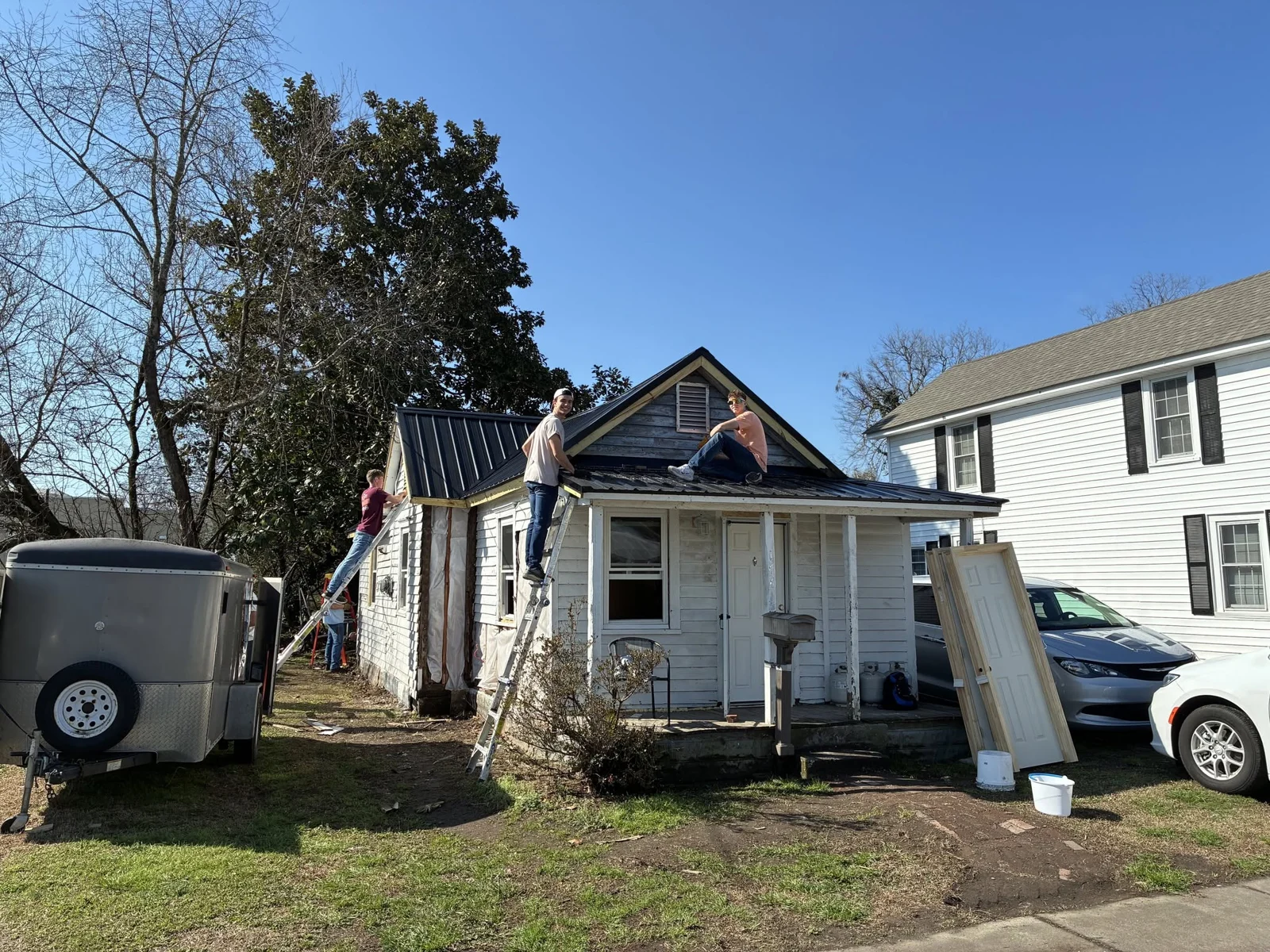 Volunteers working on the roof of a small home