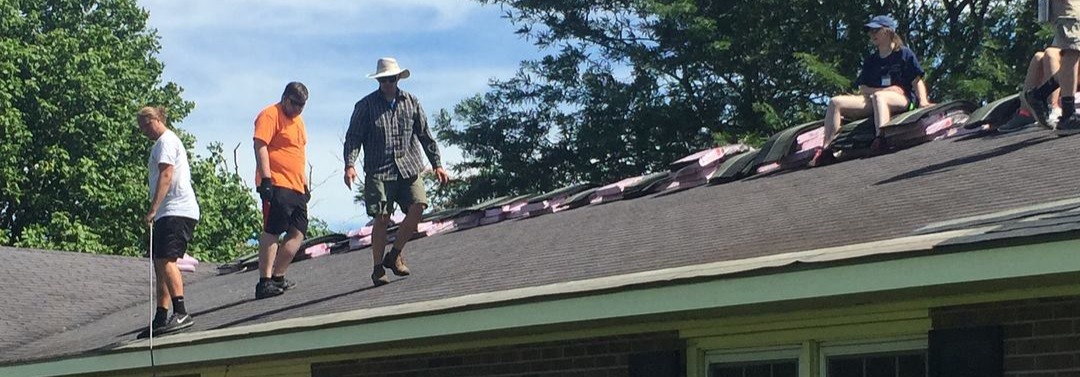 CRM volunteers working together to repair a homeowner’s roof